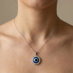 Necklace with an eye-shaped pendant worn by a model
