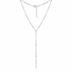 Detail of rhodium-plated 925 silver Y-drop necklace with cube bead stations and geometric bar.