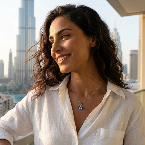 Woman wearing a 925 silver almond evil eye pendant near the Burj Khalifa, an everyday protection gift in Dubai.