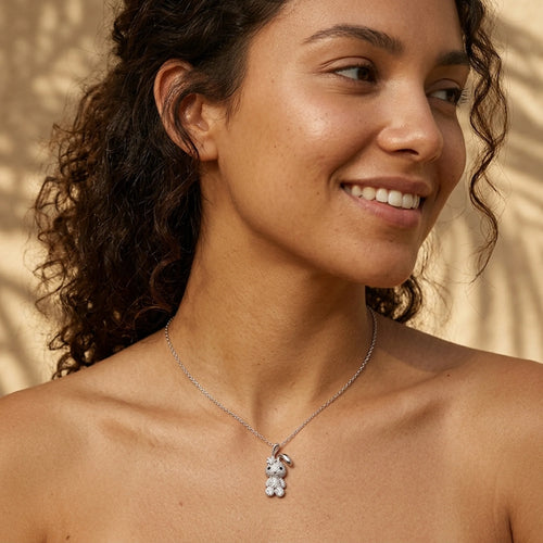 Woman wearing a 925 silver bunny pendant necklace in the sunlight in Dubai, a sparkling birthday gift.
