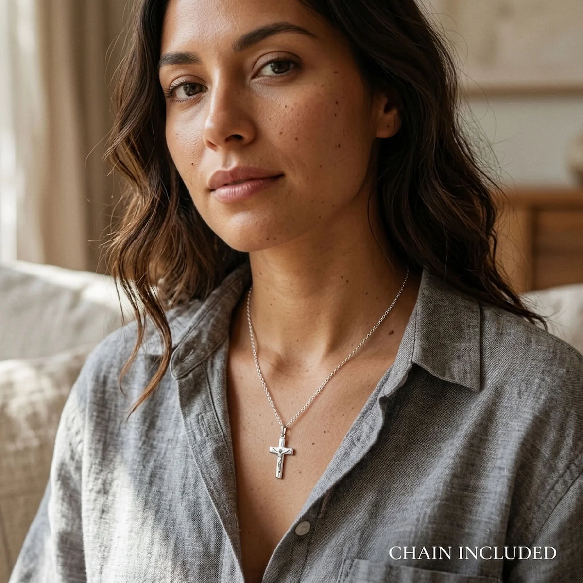 Woman wearing a small 925 silver crucifix necklace with included 45 cm sterling silver chain.