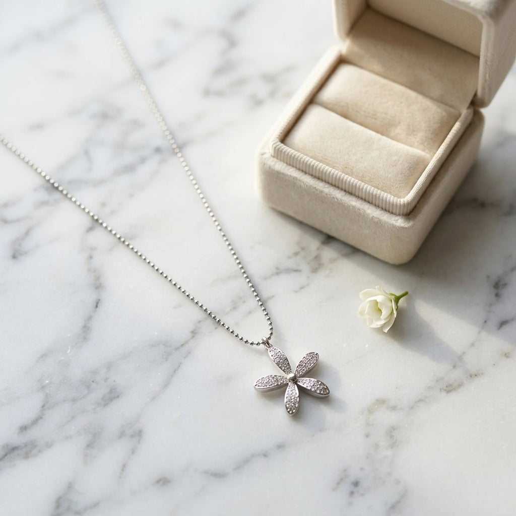 925 silver daisy pendant necklace pavé-set with cubic zirconia near a jewelry box, a gift in Dubai.