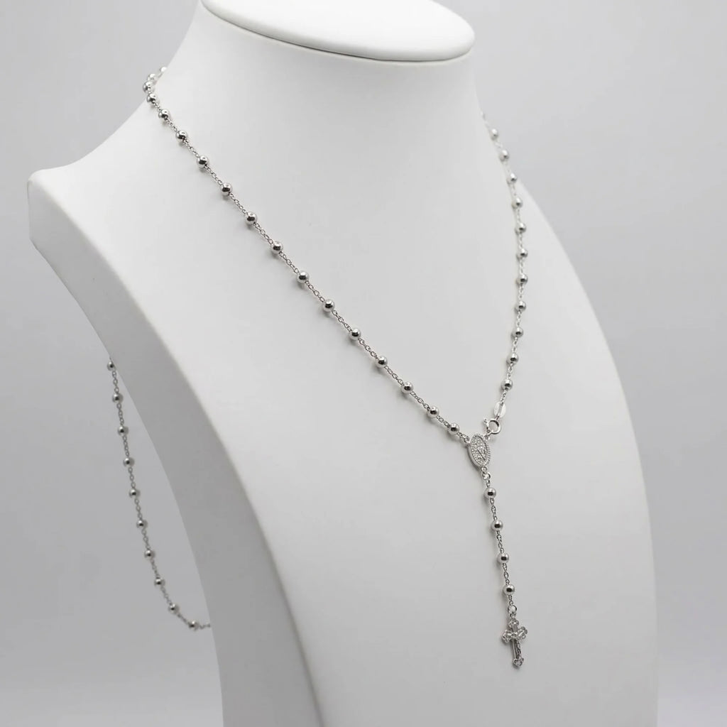 Rhodium-plated 925 silver rosary necklace on a white display bust, showing the beaded chain, Marian medal and Y-drop crucifix.