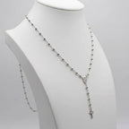 Rhodium-plated 925 silver rosary necklace on a white display bust, showing the beaded chain, Marian medal and Y-drop crucifix.