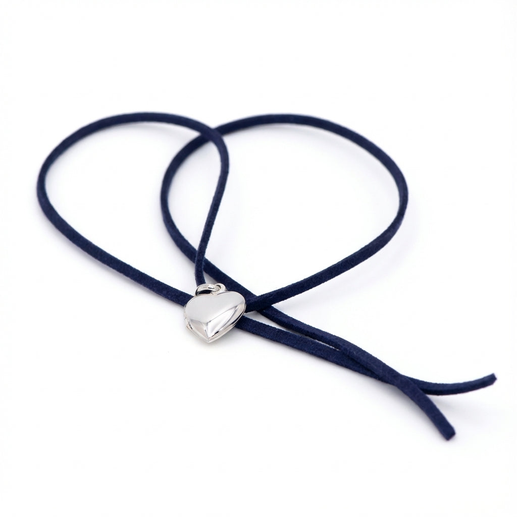 925 silver heart locket necklace on navy blue suede cord — high-polish heart pendant on white background.