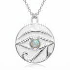 Round silver pendant with white enamel Eye of Horus design and central white opal stone