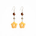 Hand-carved Yellow Carnelian flower earrings in 925 sterling silver — honey-toned 5-petal blossoms with amber crystal accents and shepherd hook closures.