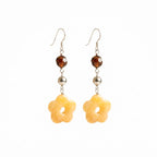 Hand-carved Yellow Carnelian flower earrings in 925 sterling silver — honey-toned 5-petal blossoms with amber crystal accents and shepherd hook closures.