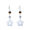 Hand-carved Snow Quartz flower earrings in 925 sterling silver — milky white 5-petal blossoms with amber crystal accents and shepherd hook closures.