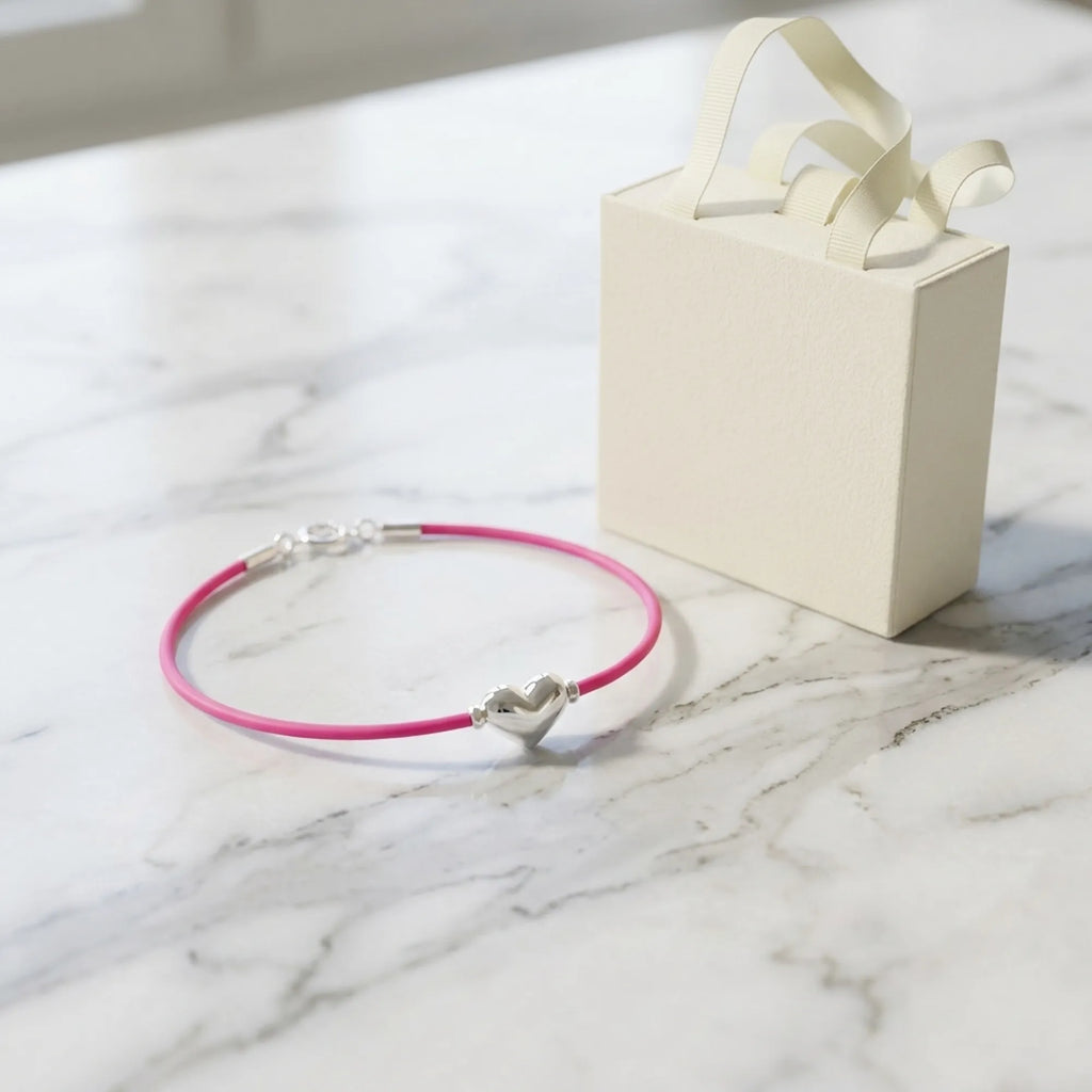 Pink cord silver heart bracelet beside a Luna Dura cream gift box, ready to give SZR Dubai 