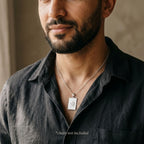 Man wearing the rectangular Allah name pendant in silver on a styling chain, which is not included with the pendant.
