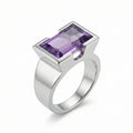 Natural amethyst cocktail ring in 925 sterling silver with open-profile half-bezel setting, 3/4 view on white background