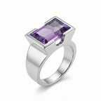Natural amethyst cocktail ring in 925 sterling silver with open-profile half-bezel setting, 3/4 view on white background