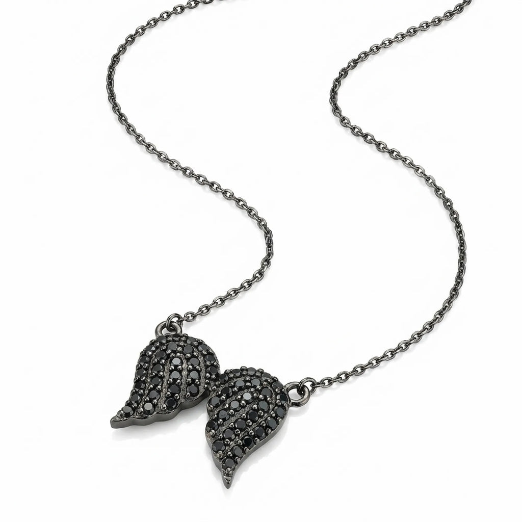Angled view of the angel wing necklace showcasing the sleek black rhodium plating and sparkling black zircon pave setting.