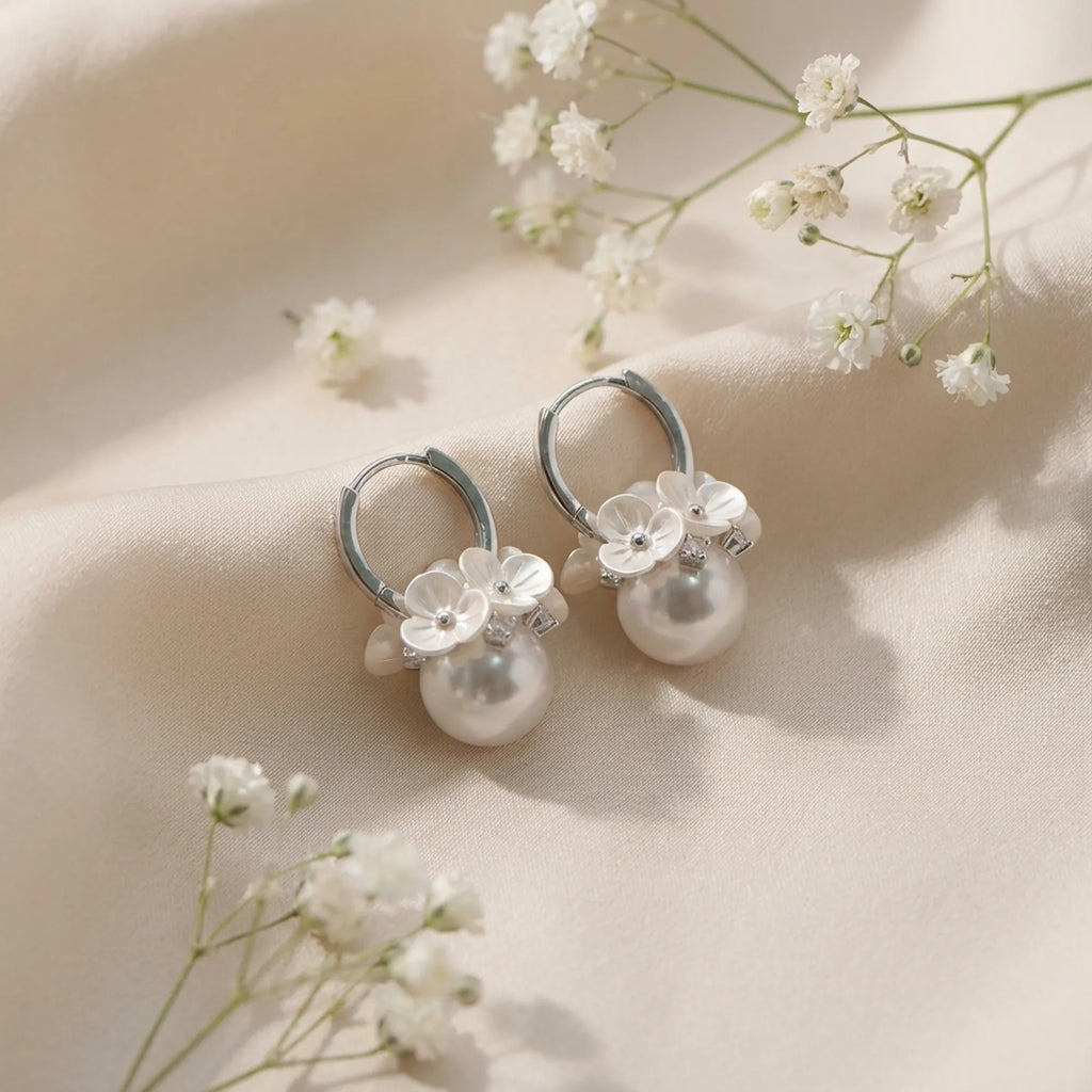 View the exquisite floral details of these artificial pearl earrings online, crafted from 925 silver and cubic zirconia.