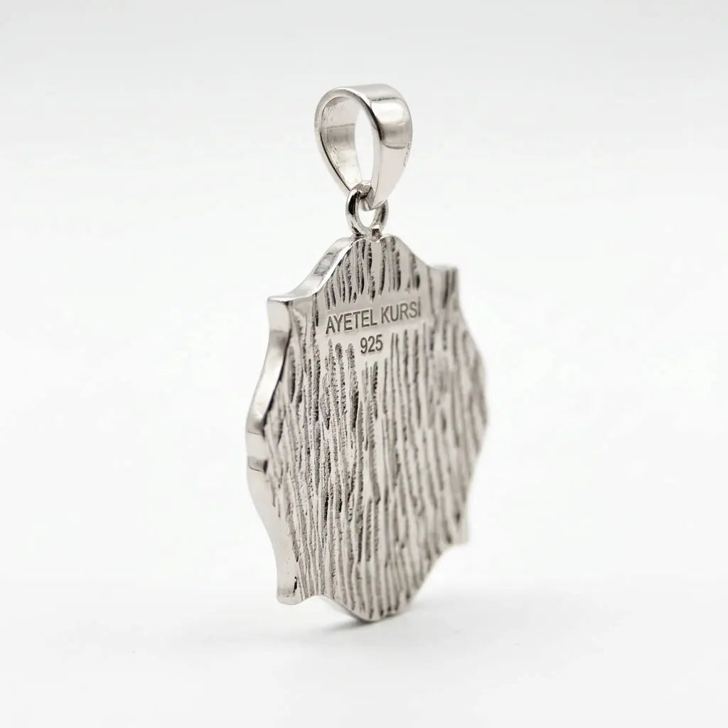 Reverse angled view of a sterling silver Ayat Al Kursi pendant showing textured back and AYETEL KURSI 925 marking.