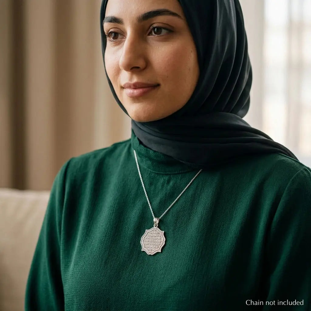 Woman wearing a 925 sterling silver Ayat Al Kursi shield pendant on a styling chain that is not included.