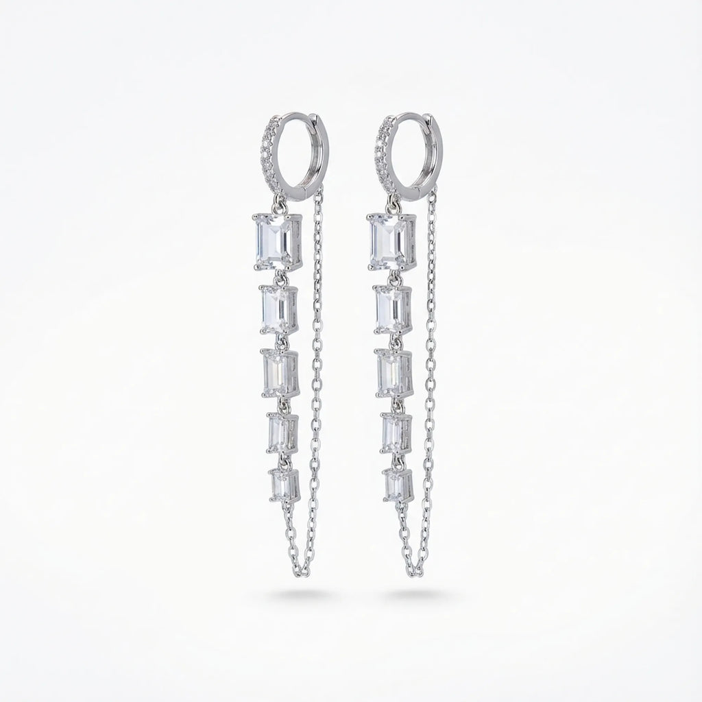 Baguette chain dangle earrings — pavé huggie hoop with five baguette CZ column and parallel cable chain, rhodium 925 silver on neutral background