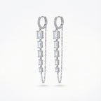 Baguette chain dangle earrings — pavé huggie hoop with five baguette CZ column and parallel cable chain, rhodium 925 silver on neutral background