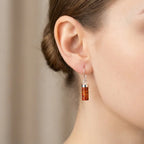 Baltic amber cylinder drop earrings in sterling silver shown on ear to demonstrate scale and elegant minimalist fit