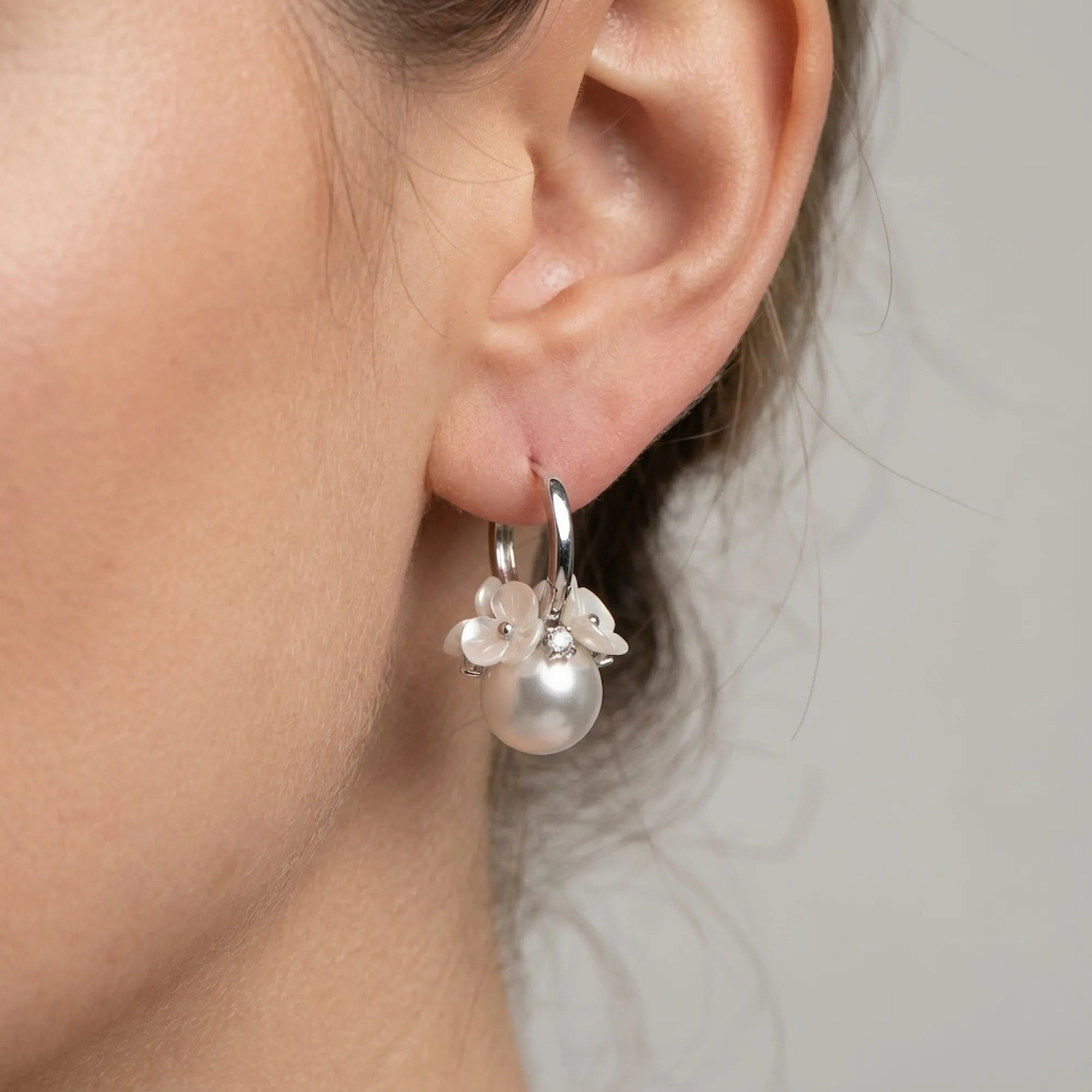 See the perfect comfortable fit of these beautiful artificial earrings featuring a simulated pearl and cubic zirconia.