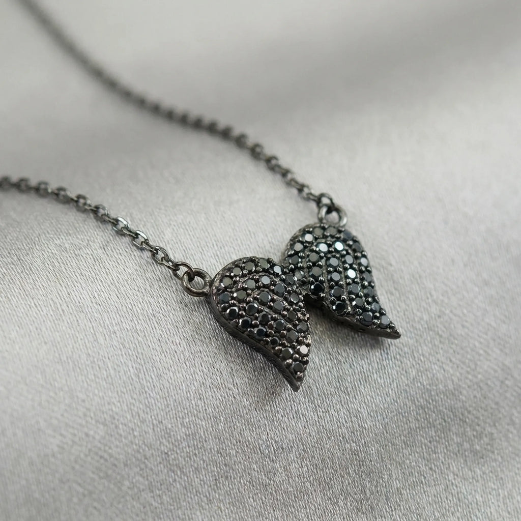 Close-up macro detail shot of the black zircon gemstones precisely set in the women's black jewelry sterling silver pendant.
