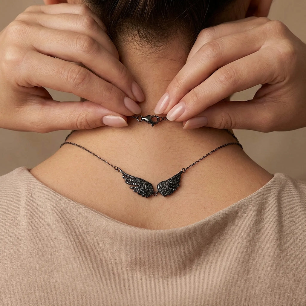 Rear view of the Black Zircon Wing Necklace highlighting the secure lobster clasp and adjustable extender chain.