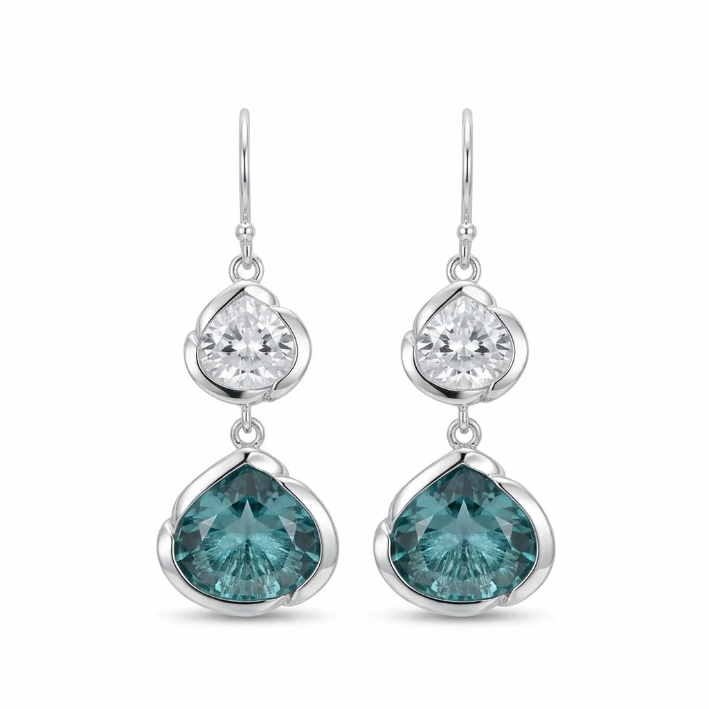 925 silver lotus dangle earrings with white topaz above sky blue topaz, on white. Luna Dura.