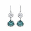 Pair of blue lotus dangle earrings in 925 sterling silver with white and sky blue topaz on a white background in Dubai.