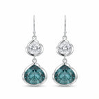 925 silver lotus dangle earrings with white topaz above sky blue topaz, on white. Luna Dura.