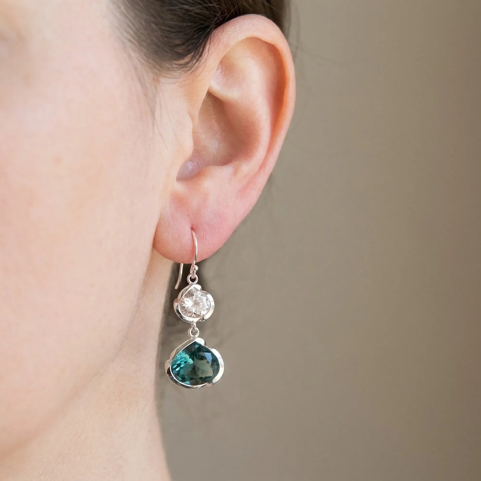 Sky blue and white topaz lotus drop earring worn at the ear, 925 silver. Luna Dura Dubai.