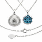 Pear-cut Sky Blue Topaz and engraved 925 silver lotus pendant front and back in Dubai.