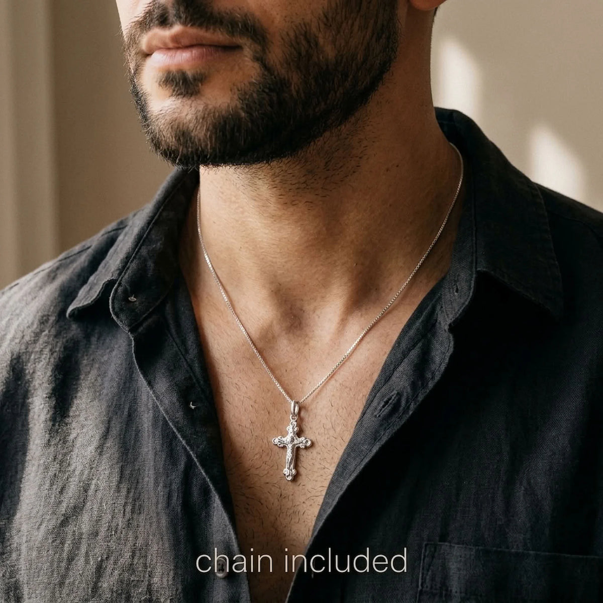 Man wearing a 925 silver cross necklace with ornate crucifix and box chain.