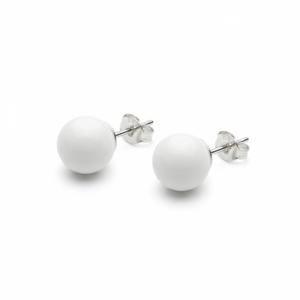 Pair of white sphere stud earrings in 925 sterling silver with polished posts and butterfly backs, on a white background.