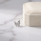 Silver butterfly pave stud earring beside a cream gift box on marble, gift-ready from Luna Dura Dubai