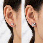 Butterfly stud worn two ways: pave butterfly alone and layered with the silver frame, on the ear, Dubai