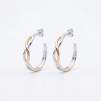 Two-tone silver and gold bypass hoop earrings on white background — interlaced wave design, post-back, 925 sterling silver.