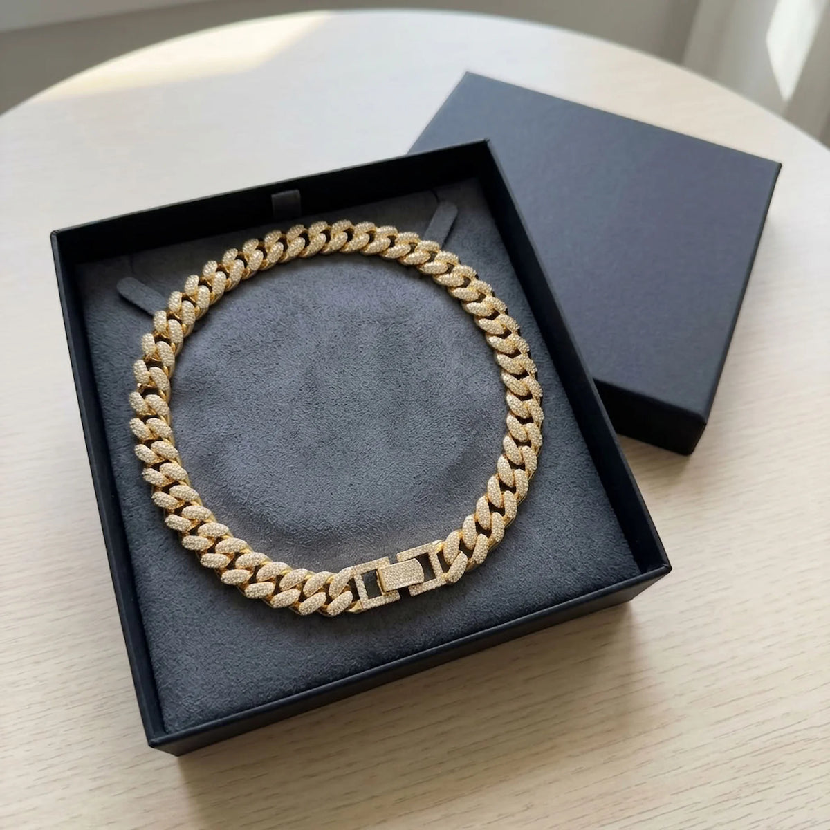 Chunky 18k gold-plated copper pave Cuban necklace featuring cubic zirconia displayed in a gift box in Dubai.