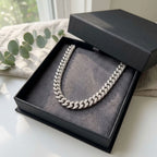 Chunky rhodium-plated copper pave Cuban necklace displayed inside a black gift box in Dubai.