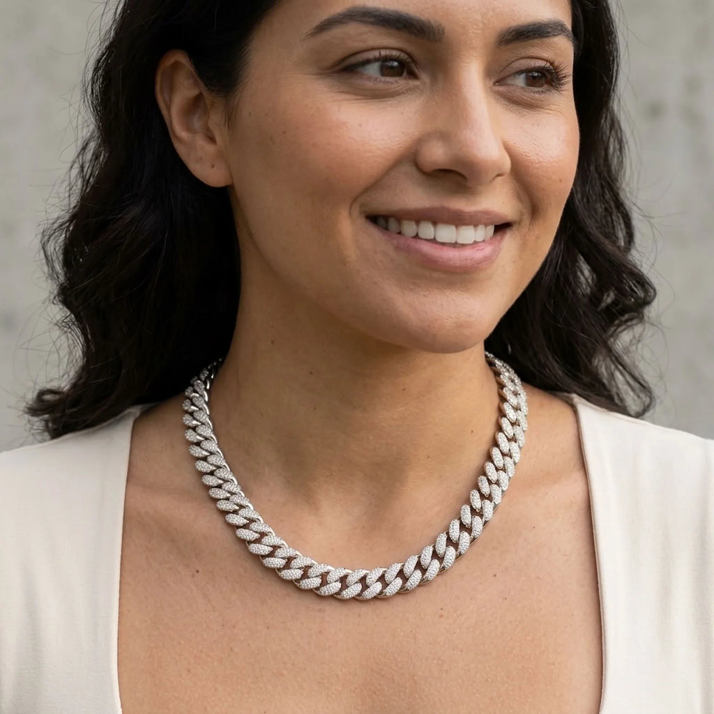 Chunky rhodium-plated copper pave Cuban necklace with cubic zirconia worn by a woman outdoors in Dubai.