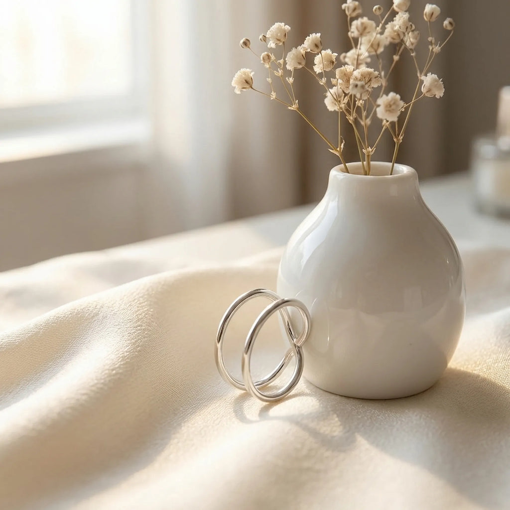 Close-up of 925 silver ear cuff double-band high-polish finish beside floral vase