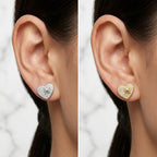 Close up of ears wearing rhodium and gold 925 silver pavé heart earrings with cubic zirconia in Dubai.
