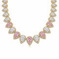 Close-up of alternating blush pink and white pear cut cubic zirconia on an 18k gold plated choker in Dubai.