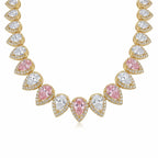 Close-up of alternating blush pink and white pear cut cubic zirconia on an 18k gold plated choker in Dubai.
