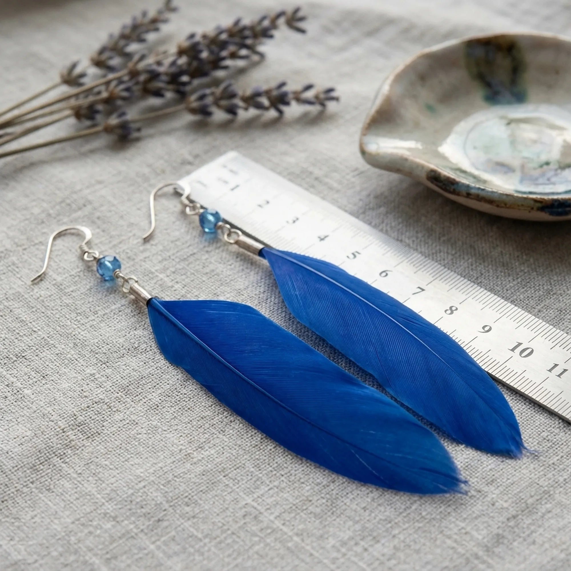 Cobalt blue feather earrings with ruler showing 8 to 10cm length — natural feather plume and 925 silver hook scale reference