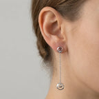 Rhodium silver crescent moon drop earring worn on ear — 925 sterling silver, 50mm chain drop, bezel CZ