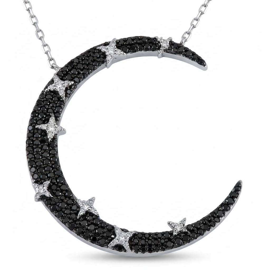 Statement crescent moon necklace in 925 silver — black zircon pavé with white star accents on rhodium chain, white background