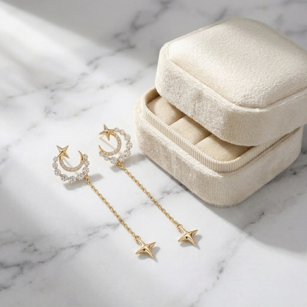 18K gold plated silver crescent moon star earrings with cubic zirconia beside a velvet box in Dubai.