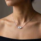 Dainty silver evil eye station necklace worn on the collarbone in Dubai for a minimalist layered look.