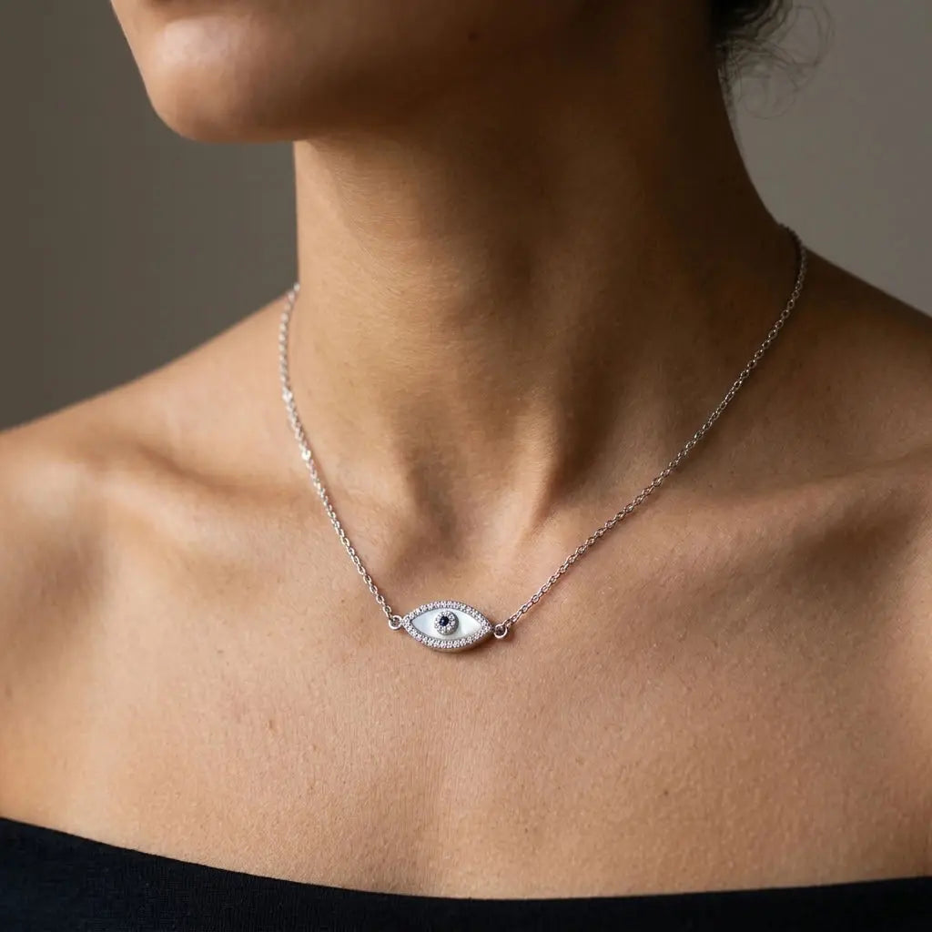 Dainty silver evil eye station necklace worn on the collarbone in Dubai for a minimalist layered look.